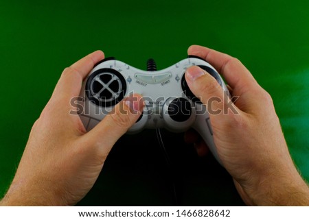 white joystick gamepad, on green background. Computer gaming competition  concept.