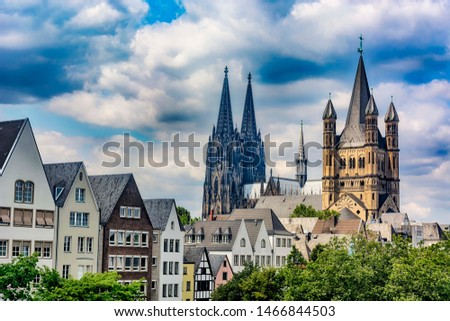 Great St. Martin Church and Kolner Dom  with old colorful houses of Cologne and cloudy sky hdr background, North Rhine-Westphalia, Germany  Royalty-Free Stock Photo #1466844503