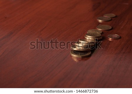 Euro coins on wooden table