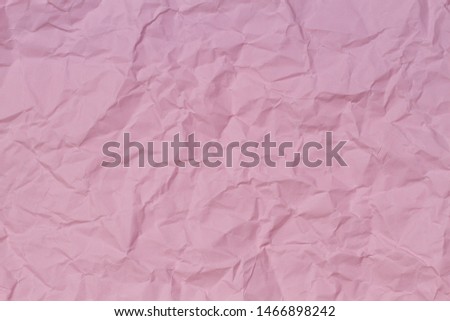 Pink crumpled wrinkled paper texture background