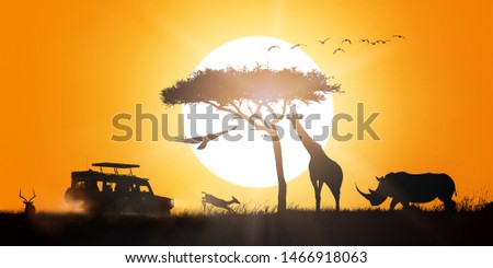 African safari sunset silhouette scene with game drive vehicle and wildlife animals Royalty-Free Stock Photo #1466918063