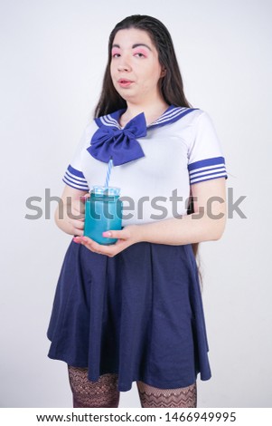 cute asian cosplay woman with chubby body stands with cup