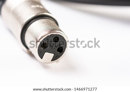 XLR connector for microphone cables isolated above white background