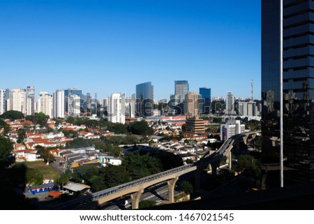 Futuristic subway train monorail over city skyscraper view. Sao Paulo Brazil..