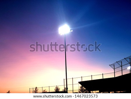 sunset with softball field light