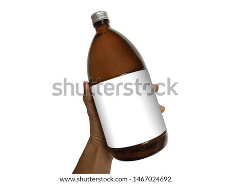 Brown glass bottle with white label in hand for medicine, chemicals, on a white background