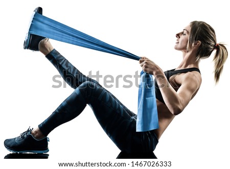 one caucasian woman exercising pilates fitness elastic resistant band exercises isolated silhouette on white background