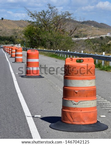 bright orange road traffic cones demarcating a work zone on the freeway.