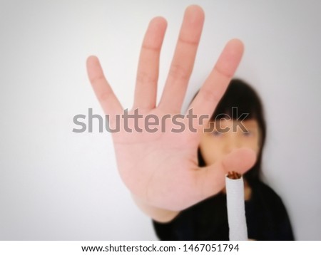 little girl refused cigarettes on white background, Smoking is harmful to health, no smoking concept, selective blur​ry image​