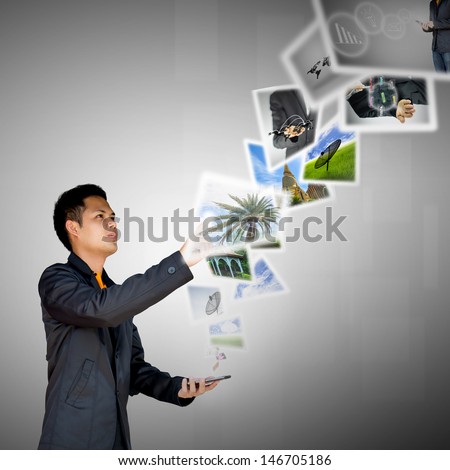 businessman push smartphone has digital image in air
