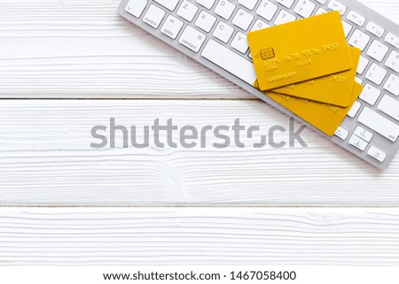 Bank card, debit, credit and keyboard for online purchase on white wooden background top view copyspace
