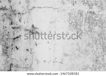 Close-up of White cement wall peeled paint caused by water and sunlight. Peel wall of White house paint with black stain. Black and White of Texture background.
