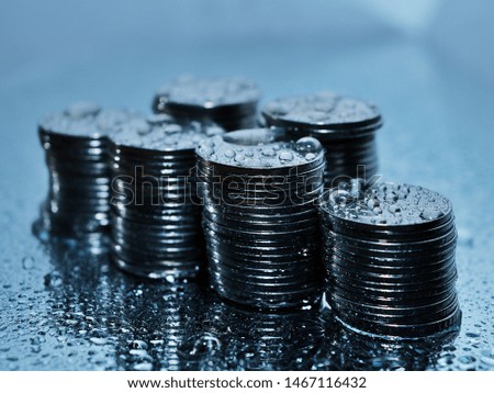 Step of coin stack with water drops. Concept of saving money, economic growth, profit business and investment for the future