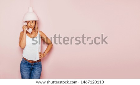 Girl talking on the phone with pink background