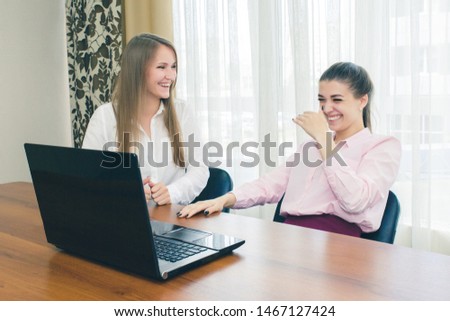 Happy business girl laughing at the Desk. Laughing girls in the workplace. Laughter