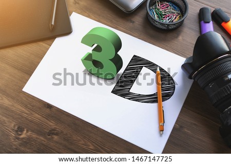3D text 3D on a sheet of papper on work desk with pen tablet, laptop, camera