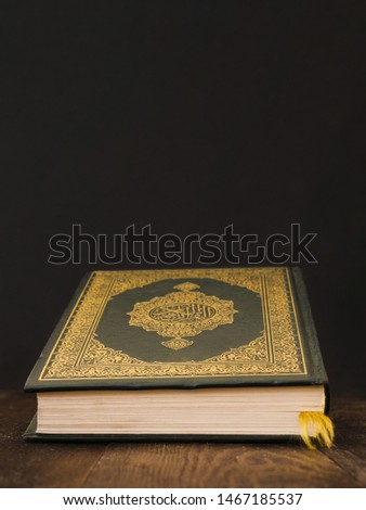 Closed quran on a table with black background