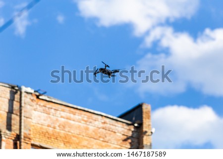 helicopter drone on a free flight over the city against the blue sky