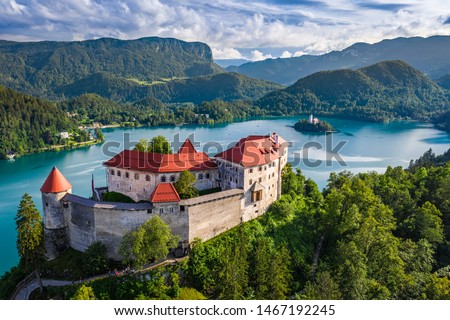Bled, Slovenia - Aerial view of beautiful Bled Castle (Blejski Grad) with Lake Bled (Blejsko Jezero), the Church of the Assumption of Maria at background on a bright summer day Royalty-Free Stock Photo #1467192245