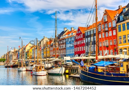 Copenhagen iconic view. Famous old Nyhavn port in the center of Copenhagen, Denmark during summer sunny day. Royalty-Free Stock Photo #1467204452