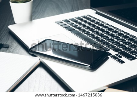 Smartphone and computer keyboard on office table close up