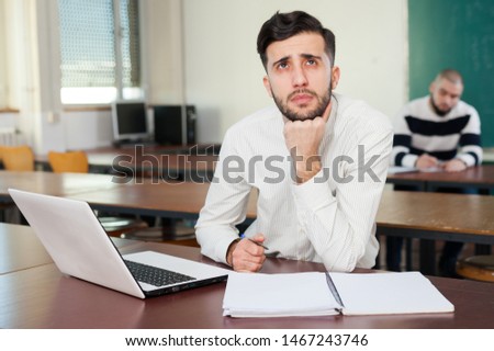 Portrait of young Arabic university student preparing for exams at classroom