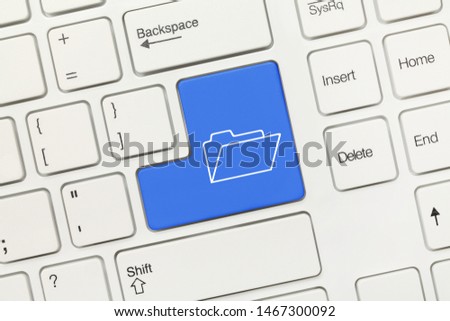 Close-up view on white conceptual keyboard - Blue key with Folder symbol