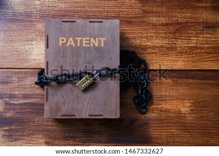Concept for copyright, patent or intellectual property and idea protection.Box wrapped with chain on lock. Royalty-Free Stock Photo #1467332627