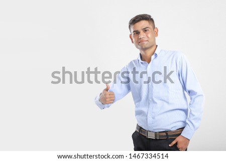 Young Indian Man Wearing suit and showing thumps up 