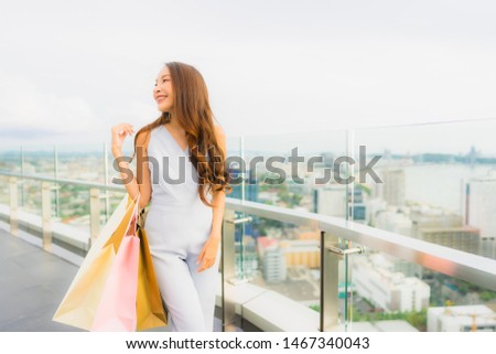 Portrait beautiful young asian woman happy and smile with shopping bag from department store mall
