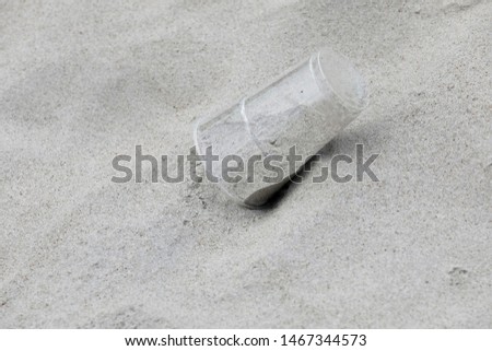 Plastic garbage was thrown away on the beach. This picture shows a common problem of environmental pollution and ecology. 