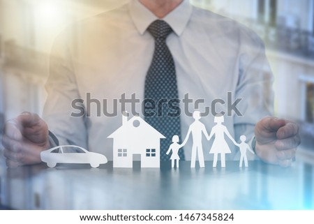 Insurer protecting a family, a house and a car with his hands; multiple exposure Royalty-Free Stock Photo #1467345824
