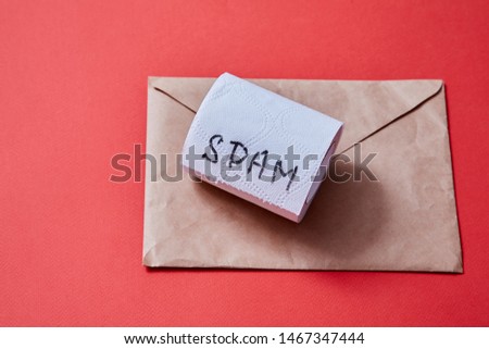 Junk mail or spam e-mail and unsolicited letter idea. A roll of toilet paper and envelope