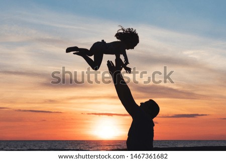 Silhouette of dad and kid against sea sky during sunset, summer family vacation travel background. Father playing with only child togetherness concept, playful bonding happiness with copy space.