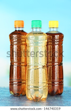Assortment of bottles with tasty drinks, on bright background