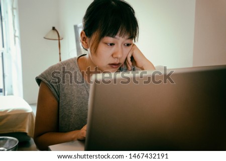 chinesse woman using her laptop computer
