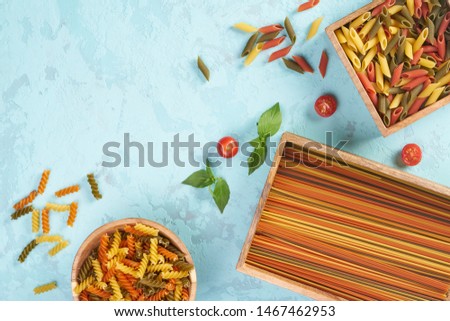 Pasta assorti on blue background with box