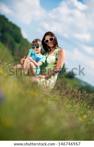 mother and daughter wearing sunglasses