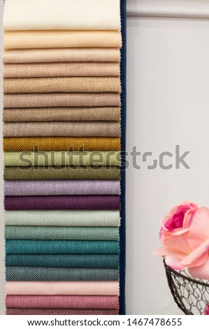 Colorful curtains fabric pattern palette texture samples as abstract textile background. Handmade, clothes and furniture decoration concept. Scraps of colored tissue close up