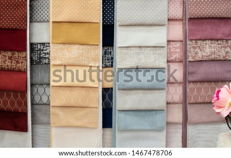 Colorful and bright curtains fabric pattern palette texture samples as abstract textile background. Handmade, clothes and furniture decoration concept. Scraps of colored tissue close up