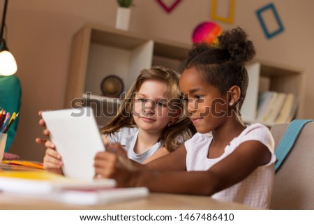 Two first grade elementary school students studying and doing homework using tablet computer. Use of modern technologies in education concept