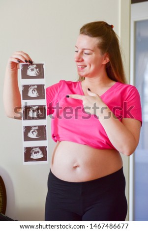 Pregnant woman holding her baby sonography