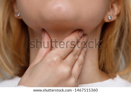 Closeup of sick woman suffering from throat problems. Thyroid gland, painful swallowing, tonsillitis, laryngeal swelling concept. Inflammation of the upper respiratory tract Royalty-Free Stock Photo #1467515360