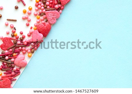 Colorful holiday background with candy on blue. Copy space for text. Greeting card for Easter, birthday , Valentine's Day. Flat lay .Top view. 