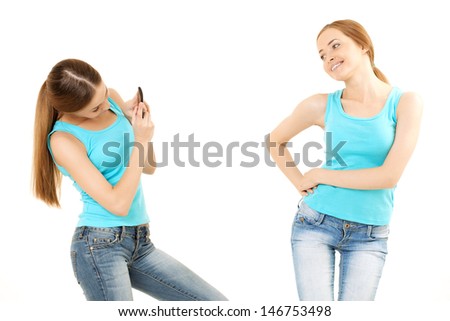 Two smiling women make the photo to mobile phone