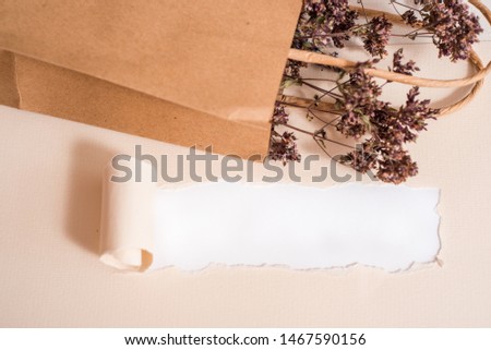mock up on a white background. Kraft pack, reusable packaging with flowers. Homemade tea, peppermint,lemon balm and hyssop flowers. Torn paper,mocap postcard. top view,copy space