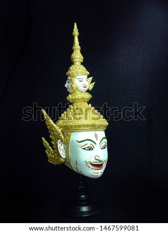 A model of thai actor's Khon mask on black background.(Thai traditional dance) Use in khon thai classical style of ramayana story. 
Brahma or phra prom mask in native thai style.