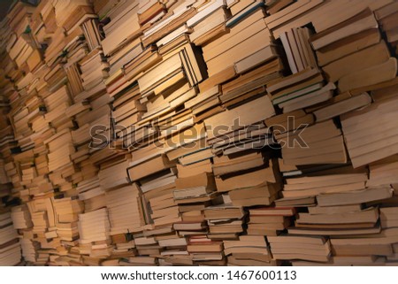 Vintage old texture for background. Shelf of books in the library, toned photo. Books on a wooden shelfs. Many books in the side. Shelf of books in the library. Concept of reading habits