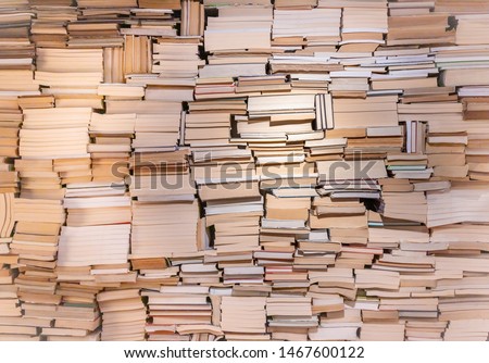 Old books on wooden shelf. Abstract blurred boxes on rows of shelves in big modern warehouse background. Huge stack of book. Vintage picture. Education background. Books on wooden shelves close-up