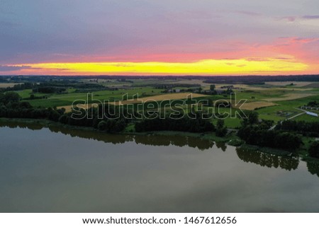 Sunset at lake view from drone with cloudy sky, island